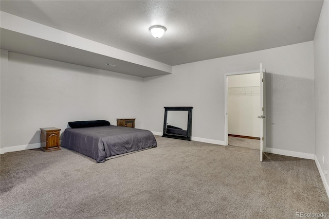 7823 E 130th Pl, Thornton, CO 80602 - carpeted bedroom with baseboards, a textured ceiling, and a walk in closet