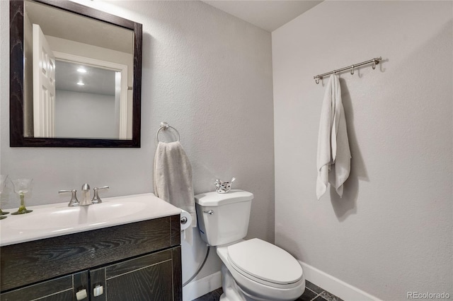 7823 E 130th Pl, Thornton, CO 80602 - bathroom featuring baseboards, toilet, and vanity