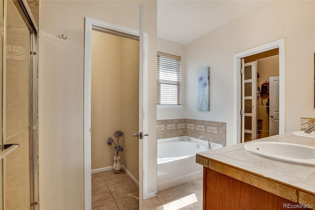 7823 E 130th Pl, Thornton, CO 80602 - full bathroom featuring tile patterned flooring, a bath, a shower stall, double vanity, and a spacious closet