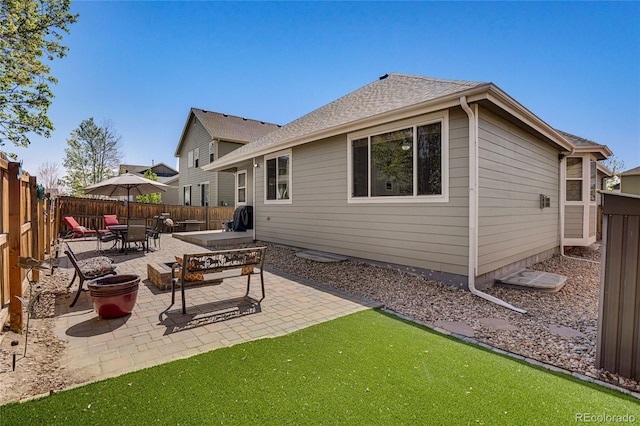 7823 E 130th Pl, Thornton, CO 80602 - back of house with a fenced backyard, a patio, and roof with shingles