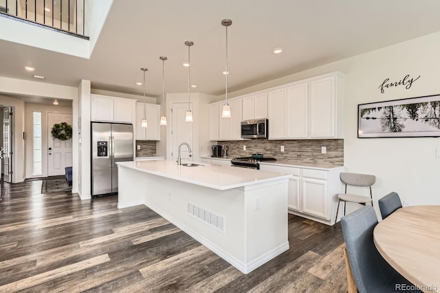 3162 Grizzly Peak Dr, Broomfield, CO 80023 - kitchen featuring stainless steel appliances, a sink, tasteful backsplash, dark wood-style floors, and light countertops