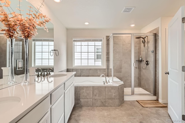 3162 Grizzly Peak Dr, Broomfield, CO 80023 - full bathroom featuring healthy amount of natural light, a shower stall, a garden tub, double vanity, and recessed lighting