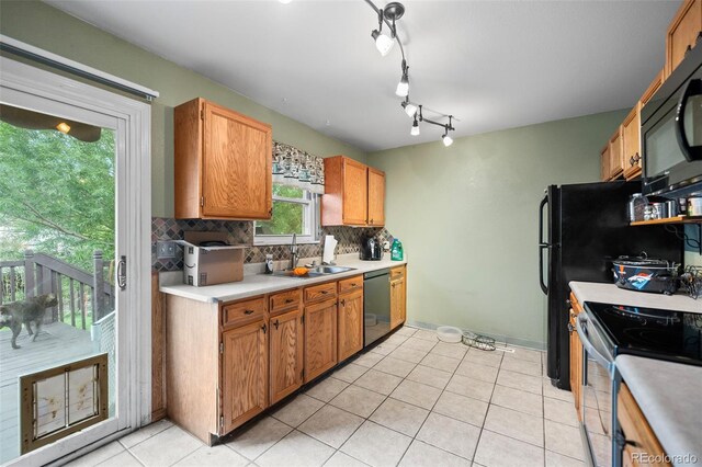 3010 Fireweed Dr, Colorado Springs, CO 80918 - kitchen featuring a sink, black microwave, dishwasher, electric stove, and backsplash