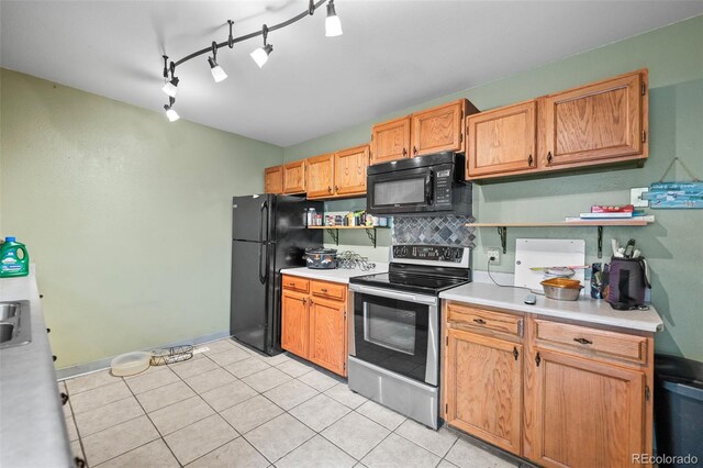 3010 Fireweed Dr, Colorado Springs, CO 80918 - kitchen with black appliances, light countertops, open shelves, rail lighting, and light tile patterned floors