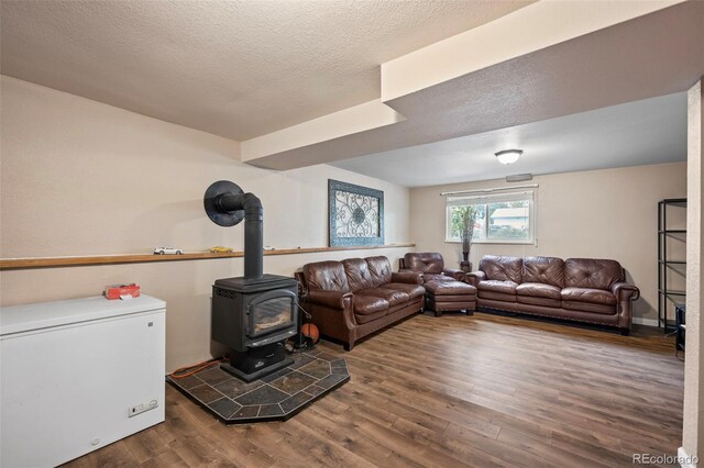 3010 Fireweed Dr, Colorado Springs, CO 80918 - living room featuring a wood stove, wood finished floors, and a textured ceiling
