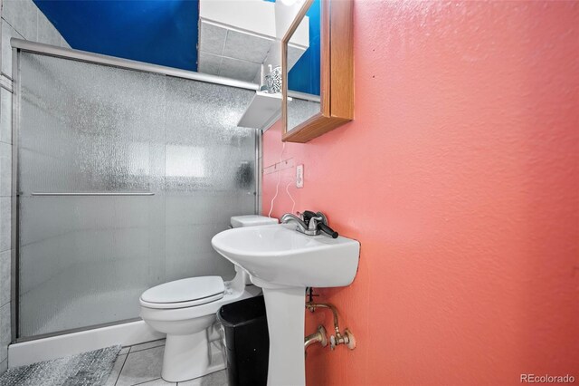 3010 Fireweed Dr, Colorado Springs, CO 80918 - bathroom with toilet, tile patterned flooring, a shower stall, and a textured wall