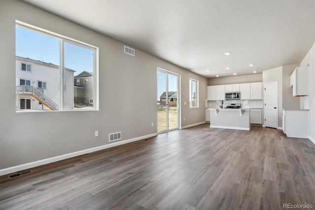 unfurnished living room with hardwood / wood-style floors