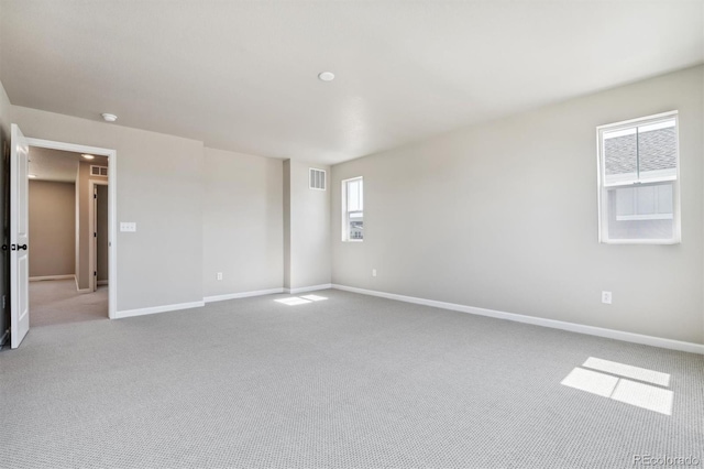 spare room featuring light colored carpet