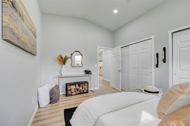 bedroom featuring light hardwood / wood-style floors and vaulted ceiling