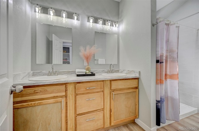 bathroom with hardwood / wood-style floors, vanity, and a shower with curtain