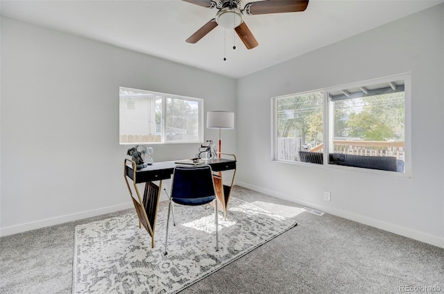 carpeted office space with a healthy amount of sunlight and ceiling fan