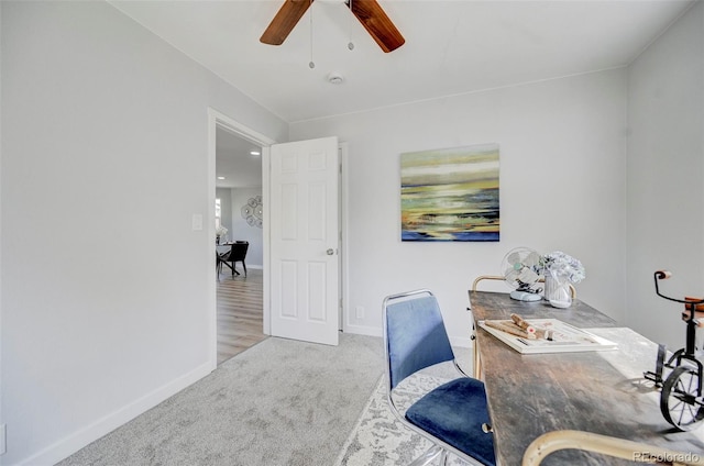 carpeted home office with ceiling fan