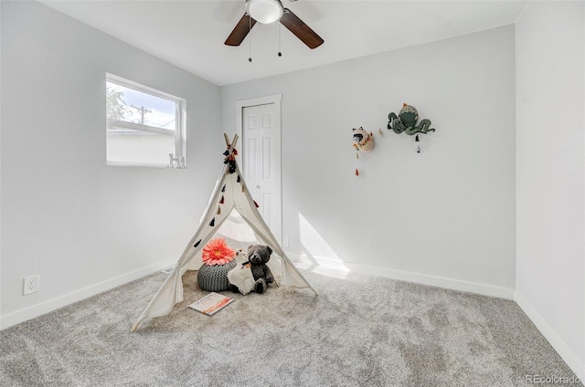 playroom with carpet flooring and ceiling fan