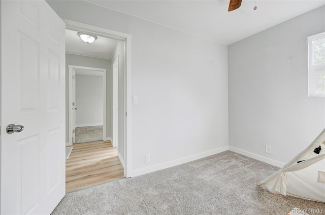 spare room with ceiling fan and light wood-type flooring