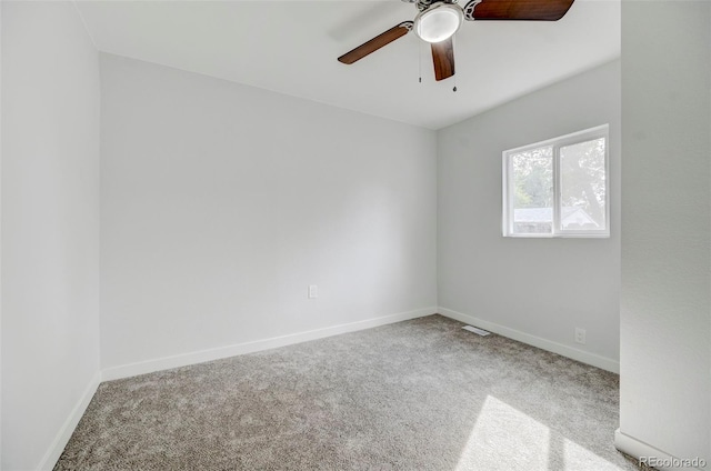 carpeted spare room featuring ceiling fan