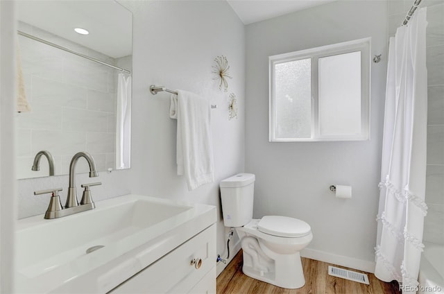 full bathroom featuring shower / bath combo, vanity, toilet, and wood-type flooring