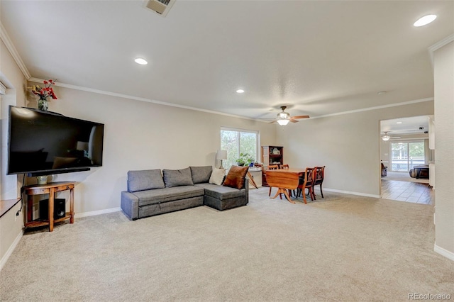 living room with a ceiling fan, carpet, ornamental molding, baseboards, and recessed lighting