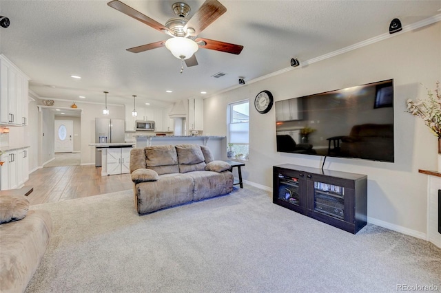 living room with ceiling fan, baseboards, crown molding, a textured ceiling, and recessed lighting