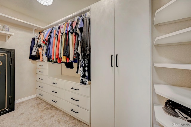spacious closet featuring light carpet