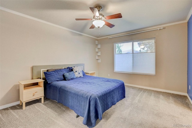 bedroom with carpet floors, baseboards, crown molding, and a ceiling fan