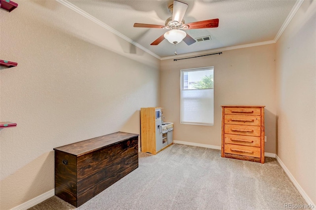 carpeted bedroom with ornamental molding, baseboards, and a ceiling fan