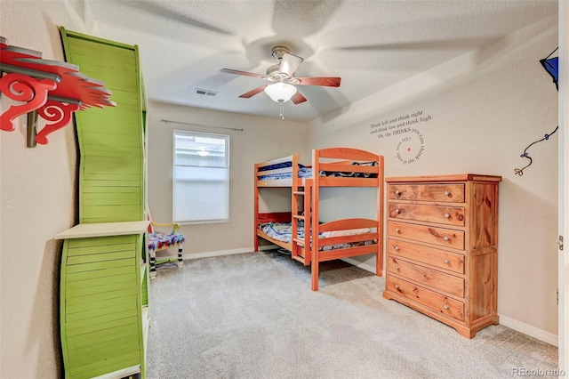 carpeted bedroom featuring a ceiling fan and baseboards