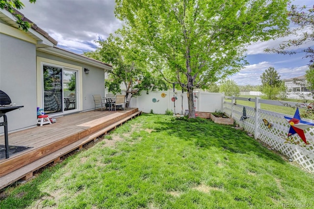 view of yard featuring a deck and outdoor dining area