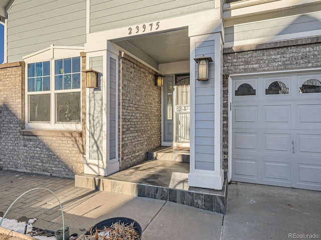 view of exterior entry featuring a garage