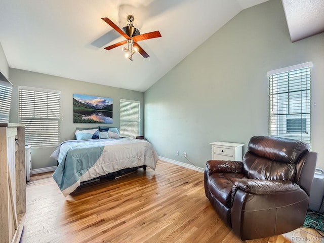 bedroom featuring ceiling fan, light hardwood / wood-style floors, and vaulted ceiling