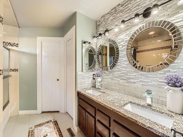 bathroom featuring tile patterned floors, decorative backsplash, vanity, and combined bath / shower with glass door