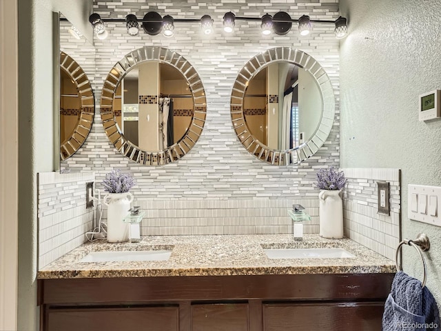 bathroom featuring vanity and tasteful backsplash