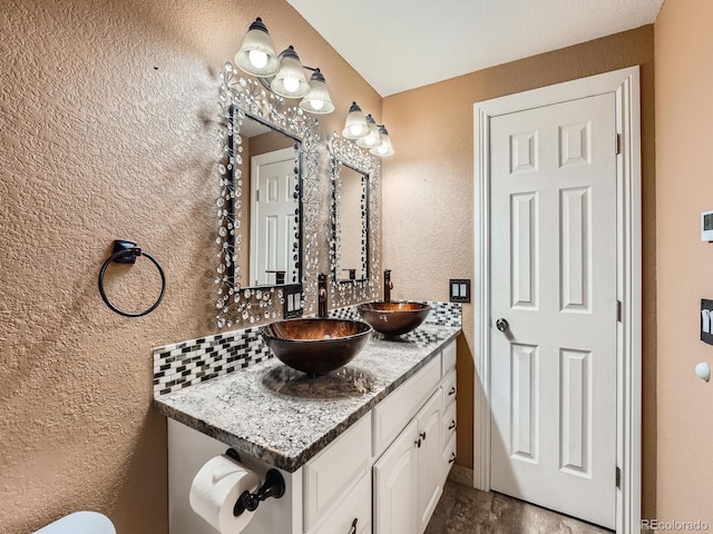 bathroom with decorative backsplash and vanity