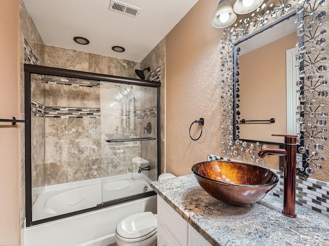 full bathroom with vanity, toilet, and enclosed tub / shower combo