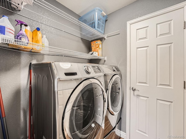 laundry area with wood-type flooring and separate washer and dryer