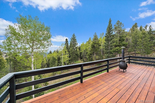 11222 Conifer Mountain Rd, Conifer, CO 80433 - wooden terrace featuring a view of trees