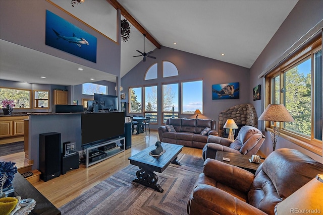 11222 Conifer Mountain Rd, Conifer, CO 80433 - living area with light wood-style flooring, beamed ceiling, ceiling fan, and high vaulted ceiling