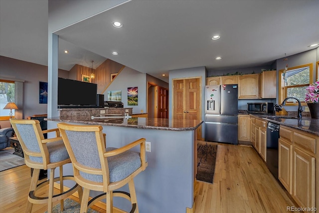 11222 Conifer Mountain Rd, Conifer, CO 80433 - kitchen with appliances with stainless steel finishes, healthy amount of natural light, a kitchen bar, light wood-style floors, and recessed lighting
