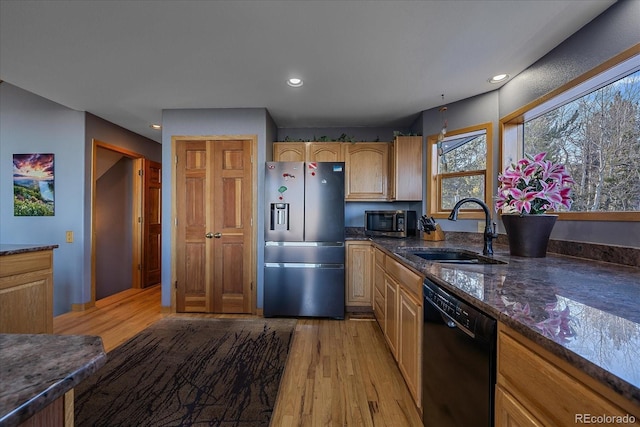 11222 Conifer Mountain Rd, Conifer, CO 80433 - kitchen featuring appliances with stainless steel finishes, light wood finished floors, recessed lighting, and dark stone countertops