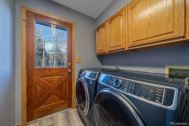 11222 Conifer Mountain Rd, Conifer, CO 80433 - washroom featuring cabinet space, separate washer and dryer, and wood finished floors