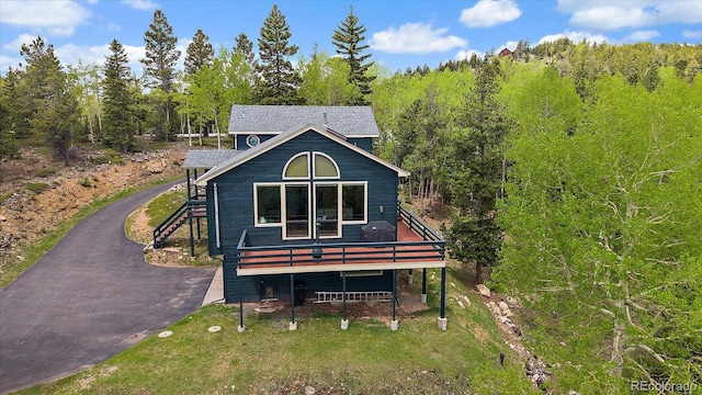 11222 Conifer Mountain Rd, Conifer, CO 80433 - view of front of house featuring a deck, asphalt driveway, and stairway