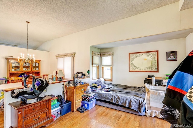 5185 E Weaver Dr, Centennial, CO 80121 - bedroom featuring wood finished floors, a chandelier, a textured ceiling, and lofted ceiling