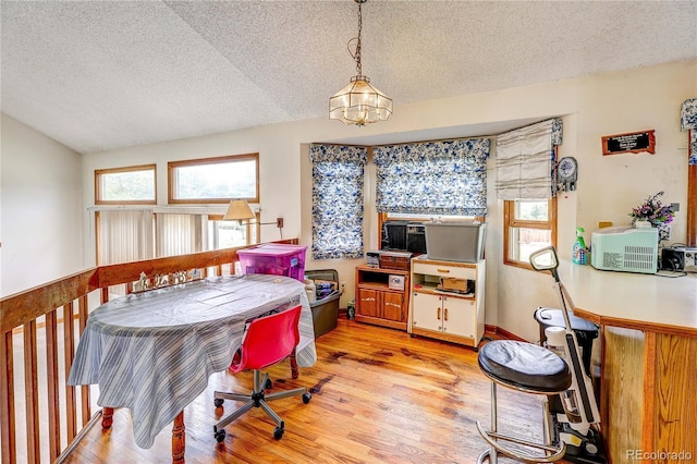 5185 E Weaver Dr, Centennial, CO 80121 - dining area with a textured ceiling, light wood-style flooring, a chandelier, and lofted ceiling