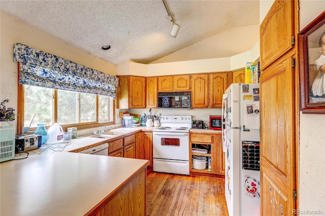 5185 E Weaver Dr, Centennial, CO 80121 - kitchen featuring white appliances, vaulted ceiling, light wood-style flooring, a textured ceiling, and light countertops