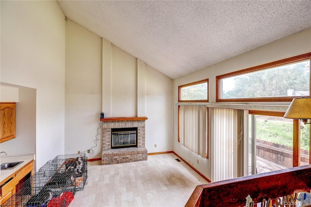 5185 E Weaver Dr, Centennial, CO 80121 - living area featuring high vaulted ceiling, a fireplace, a textured ceiling, and light wood finished floors