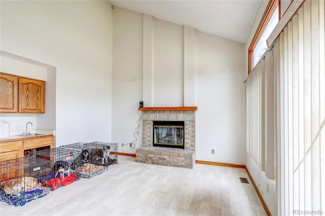 5185 E Weaver Dr, Centennial, CO 80121 - living area featuring high vaulted ceiling, light wood finished floors, and a fireplace