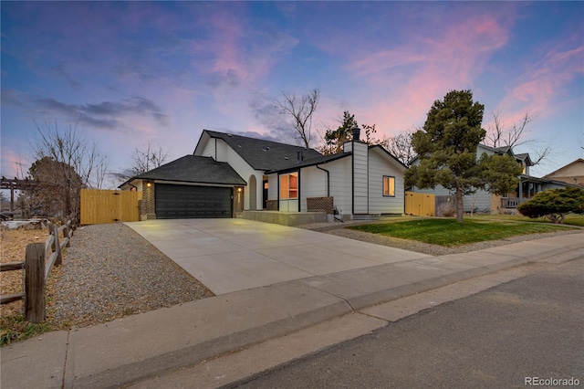 view of front of property featuring a garage and a yard