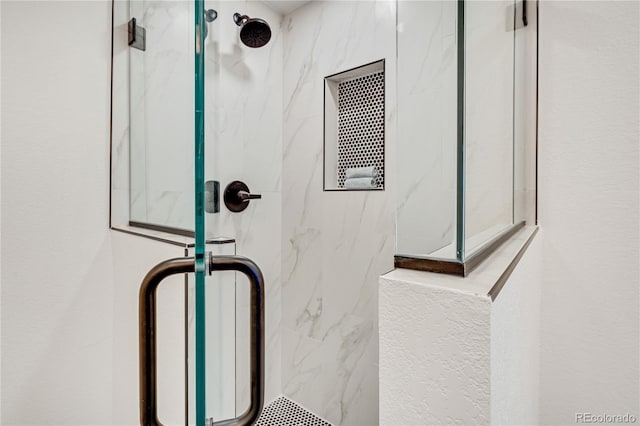 interior details featuring a shower with shower door