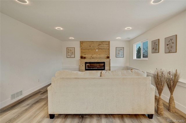 living room with a fireplace and hardwood / wood-style flooring