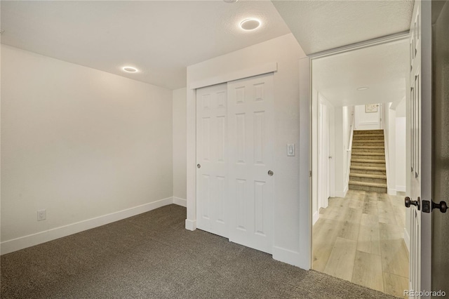 unfurnished bedroom with a closet and hardwood / wood-style floors