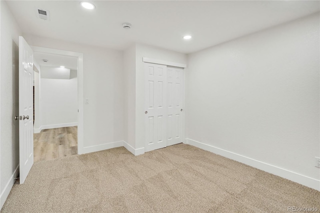 unfurnished room with light colored carpet